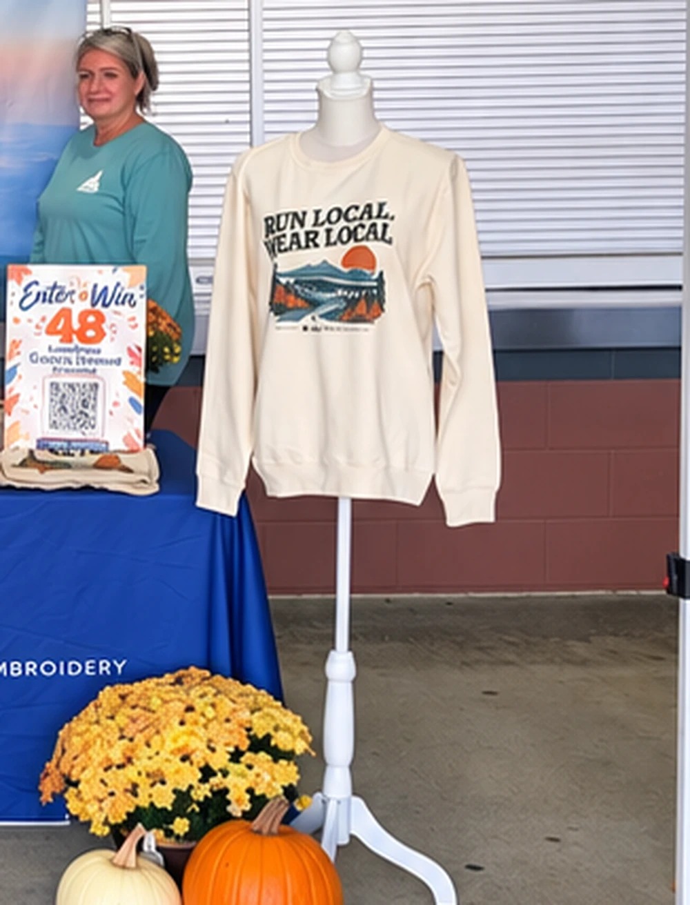 Run Local Wear Local custom screen printed fleece sweatshirt and event giveaway display at Spinx Run Fest in Greenville SC